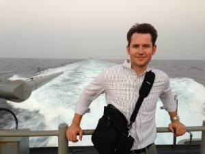 Me on the fantail of the Gettysburg with the Truman, the carrier, visible over my shou